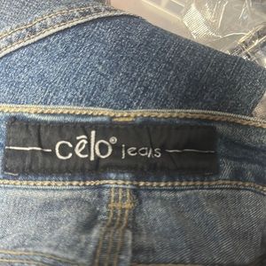 Cleo jeans - form fitting with flair appliqué design on leg. Pants show Large